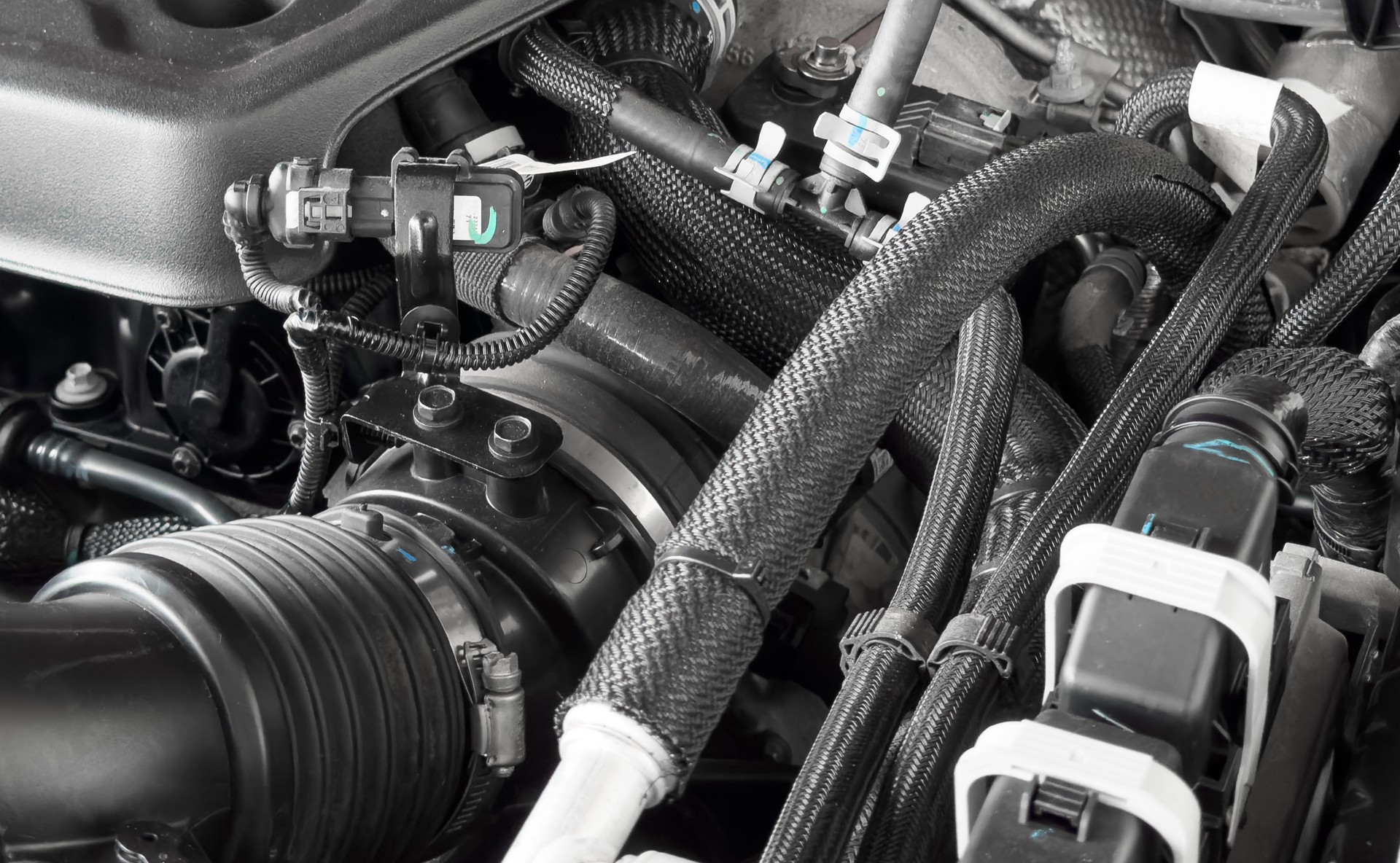 Car gasoline engine. Car engine part. Close-up image of an internal combustion engine. Engine detais in a new car.